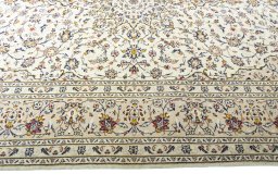 Corner detail of 2000s Kashan rug showing border pattern and Wool pile