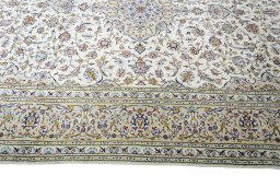 Corner detail of 2000s Kashan rug showing border pattern and Wool pile