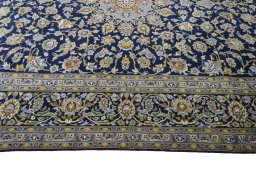 Corner detail of 2000s Kashan rug showing border pattern and Wool pile