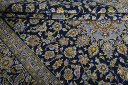 Close-up detail of 2000s Kashan rug from Iran / Persia showing Wool weave