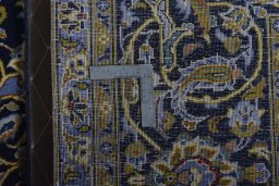Backside of handmade 2000s Kashan rug showing knot structure and weave density