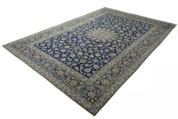 Corner detail of 2000s Kashan rug showing border pattern and Wool pile