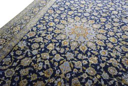 Backside of handmade 2000s Kashan rug showing knot structure and weave density