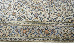 Corner detail of 2000s Kashan rug showing border pattern and Wool pile