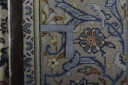 Backside of handmade 2000s Kashan rug showing knot structure and weave density