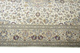 Corner detail of 2000s Kashan rug showing border pattern and Wool pile