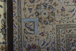 Backside of handmade 2000s Kashan rug showing knot structure and weave density