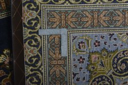 Backside of handmade 2000s Kashan rug showing knot structure and weave density