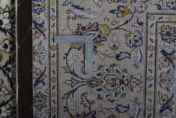 Backside of handmade 2000s Kashan rug showing knot structure and weave density