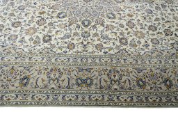 Corner detail of 2000s Kashan rug showing border pattern and Wool pile