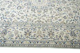Corner detail of 2000s Kashan rug showing border pattern and Wool pile