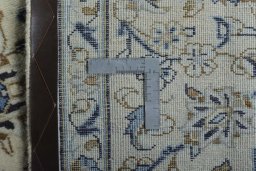 Backside of handmade 2000s Kashan rug showing knot structure and weave density