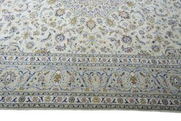 Corner detail of 2000s Kashan rug showing border pattern and Wool pile