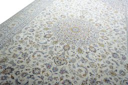 Backside of handmade 2000s Kashan rug showing knot structure and weave density
