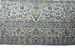Corner detail of 2000s Kashan rug showing border pattern and Wool pile