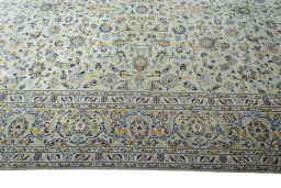 Corner detail of 2000s Kashan rug showing border pattern and Wool pile