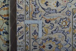 Backside of handmade 2000s Kashan rug showing knot structure and weave density