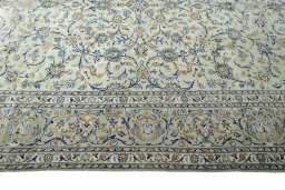 Corner detail of 2000s Kashan rug showing border pattern and Wool pile