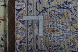 Backside of handmade 2000s Kashan rug showing knot structure and weave density