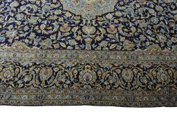 Corner detail of 2000s Kashan rug showing border pattern and Wool pile