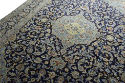 Backside of handmade 2000s Kashan rug showing knot structure and weave density