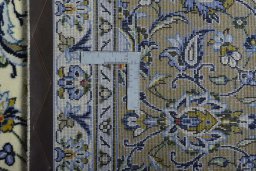 Backside of handmade 2000s Kashan rug showing knot structure and weave density