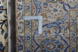 Backside of handmade 2000s Kashan rug showing knot structure and weave density