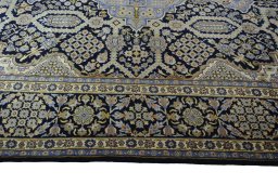 Corner detail of 2000s Kashan rug showing border pattern and Wool pile