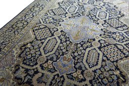 Backside of handmade 2000s Kashan rug showing knot structure and weave density