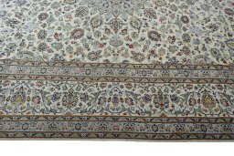 Corner detail of 2000s Kashan rug showing border pattern and Wool pile
