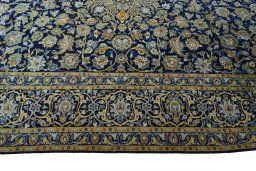 Corner detail of 2000s Kashan rug showing border pattern and Wool pile