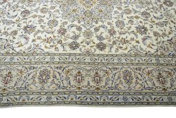 Corner detail of 2000s Kashan rug showing border pattern and Wool pile