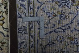 Backside of handmade 2000s Kashan rug showing knot structure and weave density