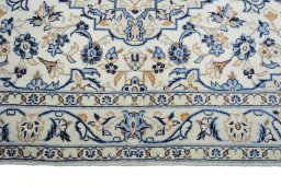 Corner detail of New Kashan rug showing border pattern and Wool pile