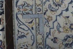 Backside of handmade New Kashan rug showing knot structure and weave density