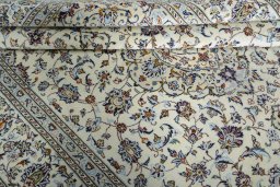 Corner detail of 2000s Kashan rug showing border pattern and Wool pile