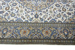 Corner detail of 2000s Kashan rug showing border pattern and Wool pile