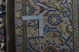 Backside of handmade 2000s Kashan rug showing knot structure and weave density