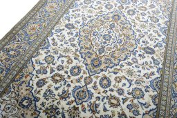 Backside of handmade 2000s Kashan rug showing knot structure and weave density