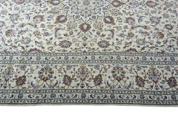 Corner detail of 2000s Kashan rug showing border pattern and Wool pile