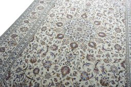 Backside of handmade 2000s Kashan rug showing knot structure and weave density