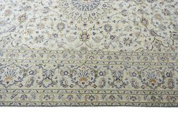 Corner detail of 2000s Kashan rug showing border pattern and Wool pile