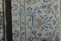 Backside of handmade 2000s Kashan rug showing knot structure and weave density