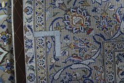 Backside of handmade 2000s Kashan rug showing knot structure and weave density