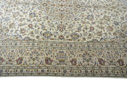 Corner detail of 2000s Kashan rug showing border pattern and Wool pile