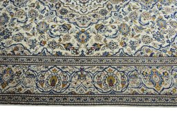 Corner detail of 2000s Kashan rug showing border pattern and Wool pile