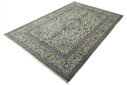 Corner detail of 2000s Kashan rug showing border pattern and Wool pile