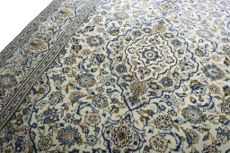 Backside of handmade 2000s Kashan rug showing knot structure and weave density