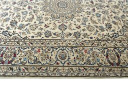 Corner detail of 2000s Kashan rug showing border pattern and Wool pile