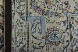 Backside of handmade 2000s Kashan rug showing knot structure and weave density